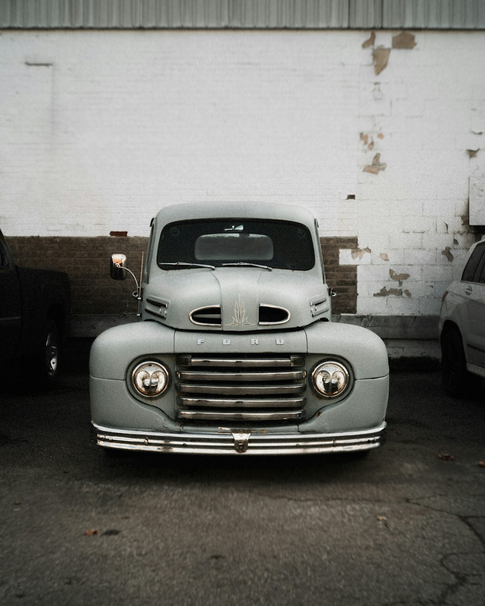 vintage gray vehicle parking near building