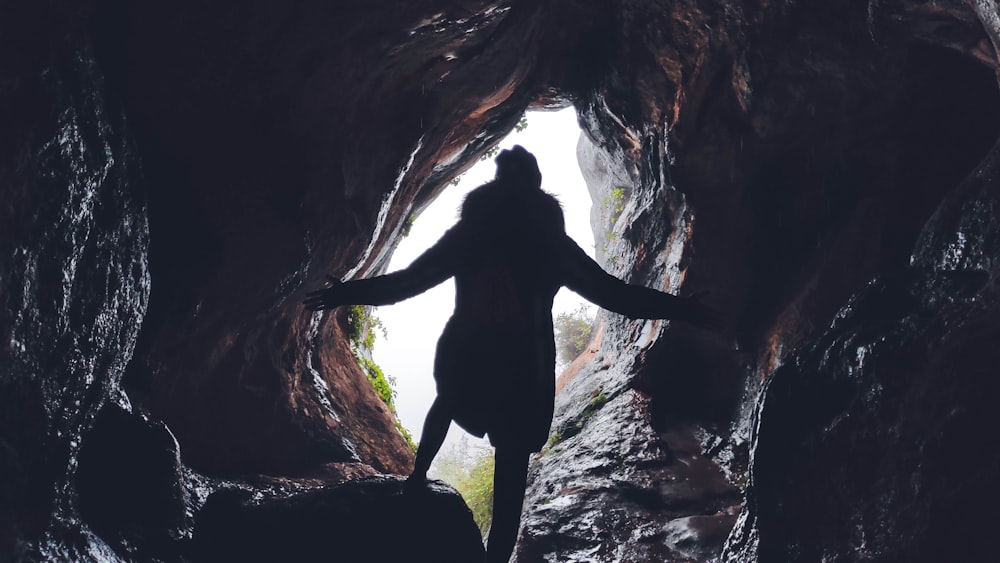 person inside cave during day