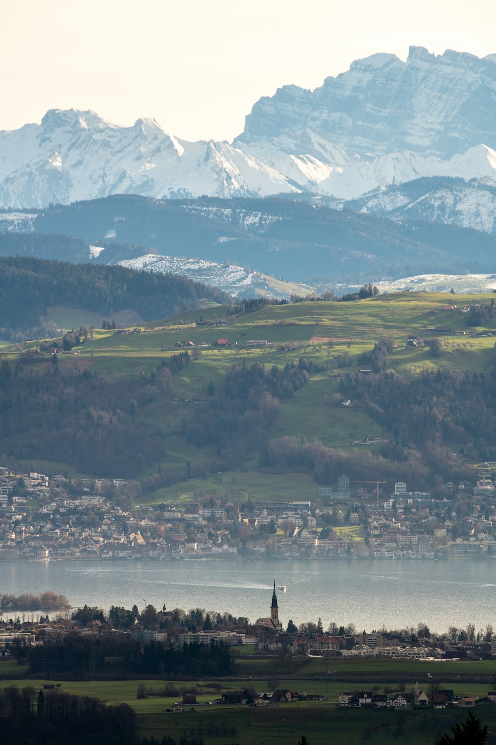 city, mountains, and sea during day