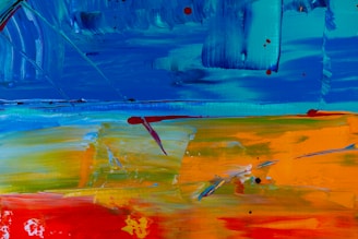 Close-up of colorful abstract paint strokes blending on canvas.