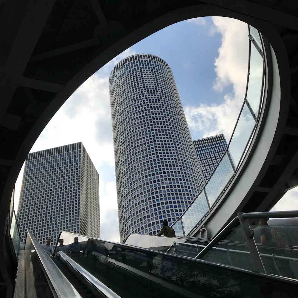 people standing on escalators during day