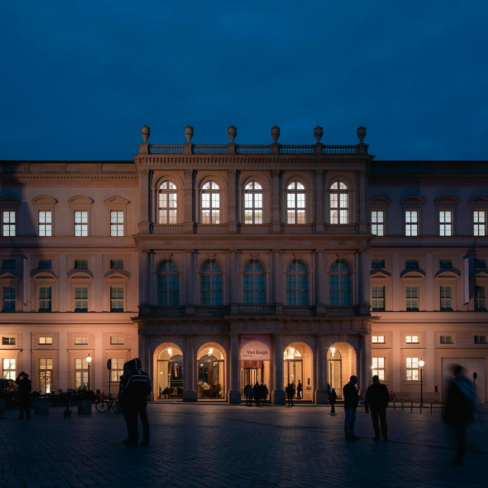 a group of people standing in front of a building