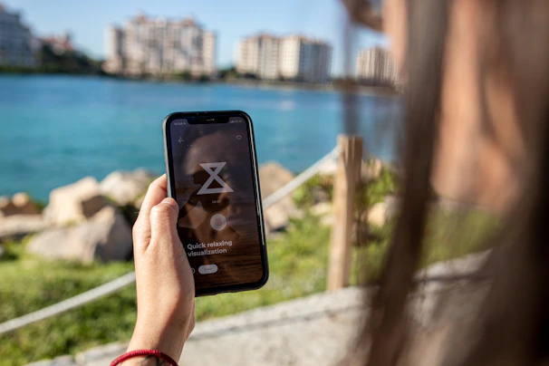A peaceful setting with a person reflecting while taking a wellness quiz on a smartphone.