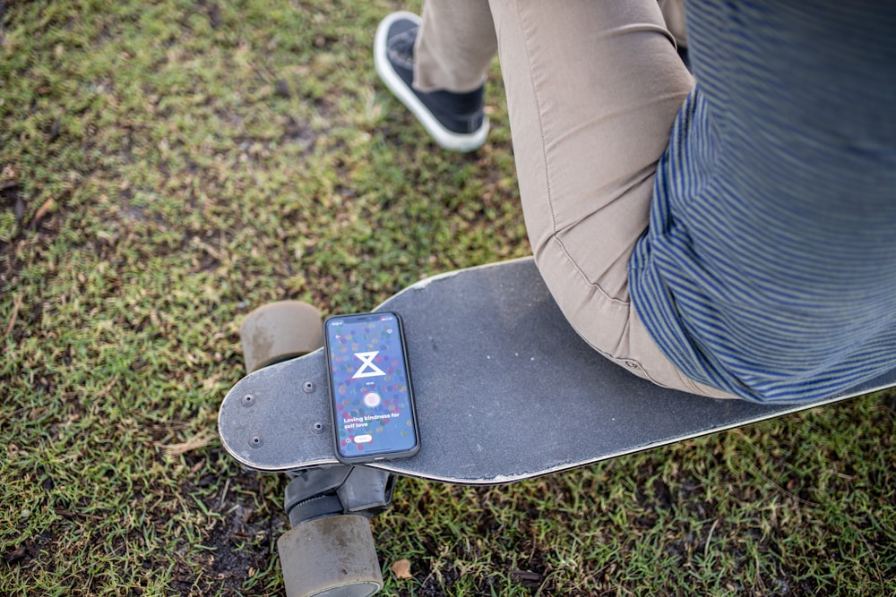 person sitting on longboard