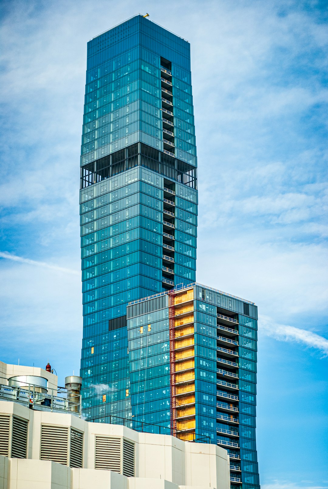 blue curtain wall building during daytime