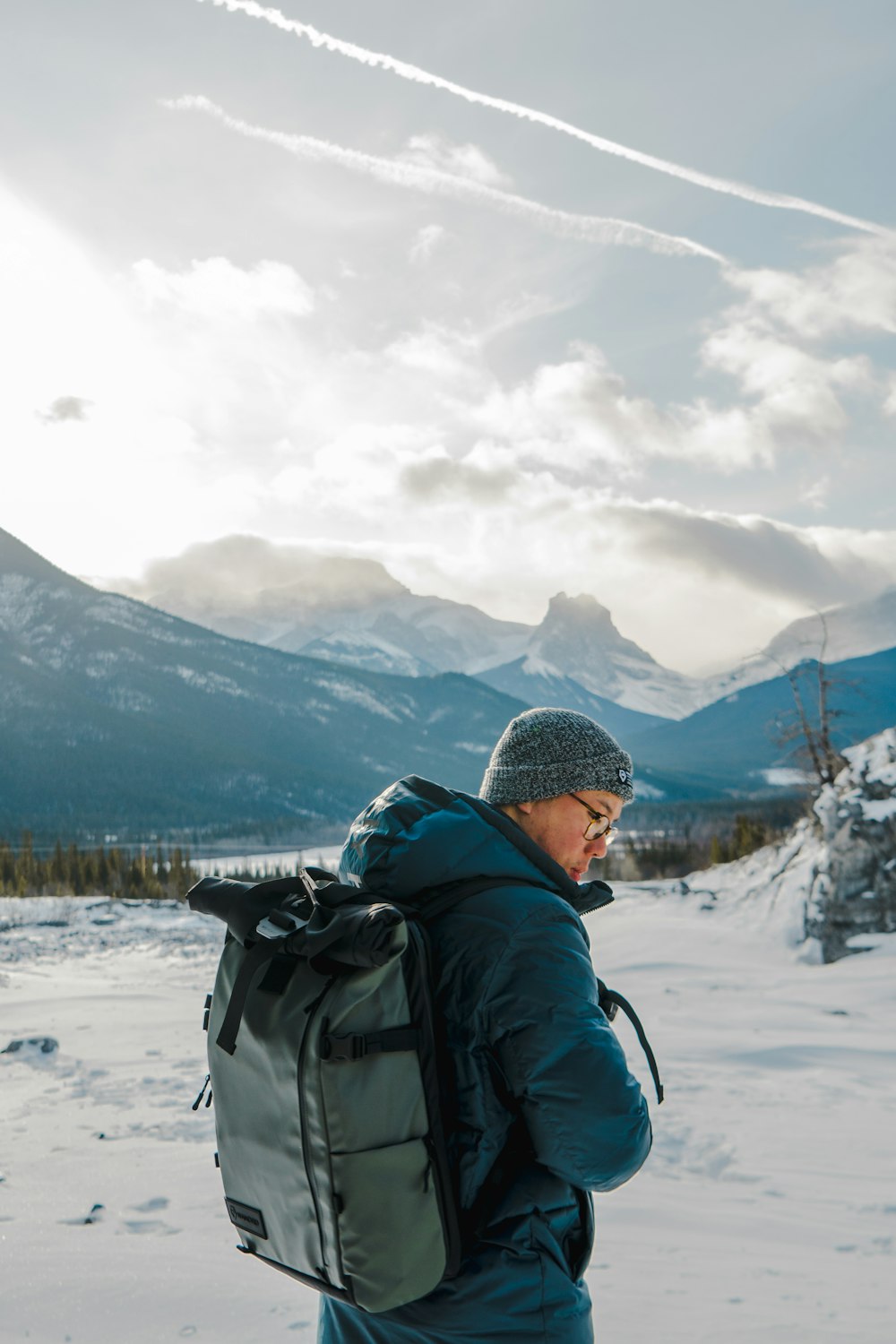 man wearing black coat carrying backpack