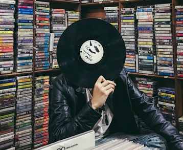 person holding black vinyl disc