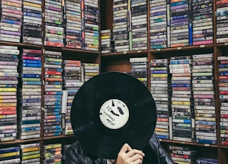 person holding black vinyl disc