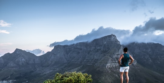 man standing on cliff in Cape Town South Africa