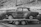 Image of a vintage car being carefully unloaded from an enclosed transport trailer
