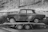 Image of a vintage car being carefully unloaded from an enclosed transport trailer