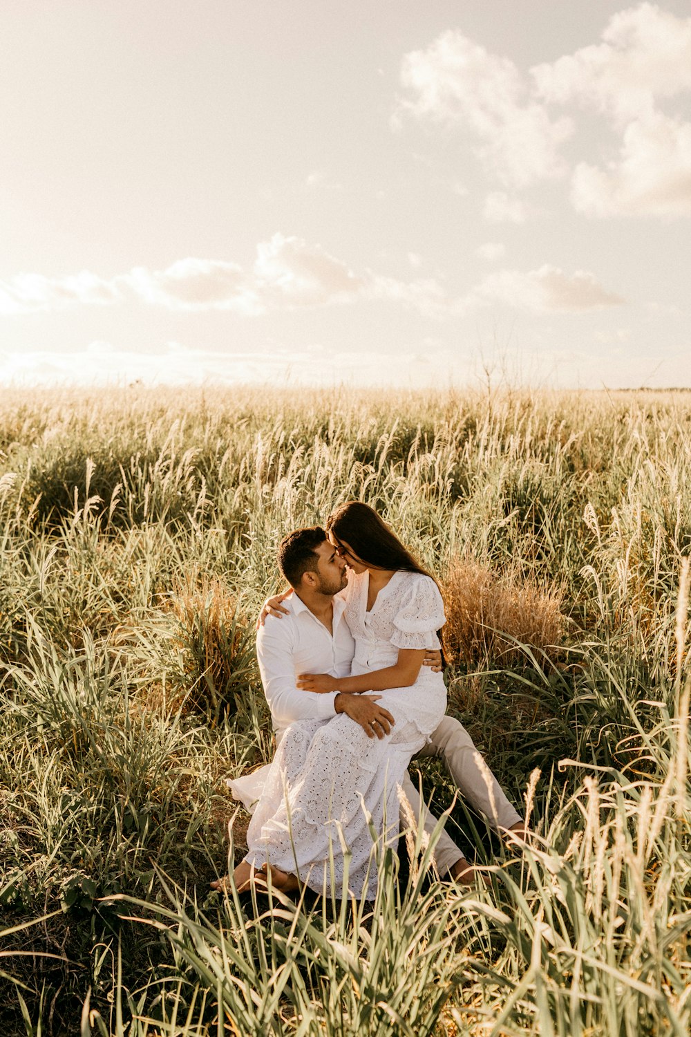 woman sitting on man looking each other during daytime