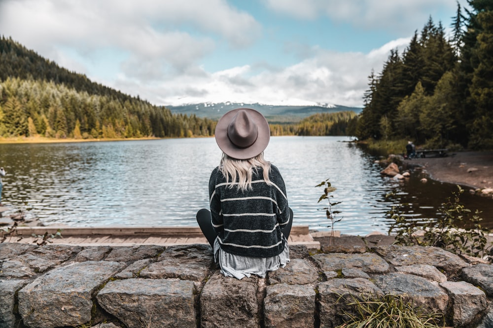 woman sitting on wall