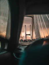 A panoramic view of a modern highway bridge under construction at sunset, showcasing engineering excellence.