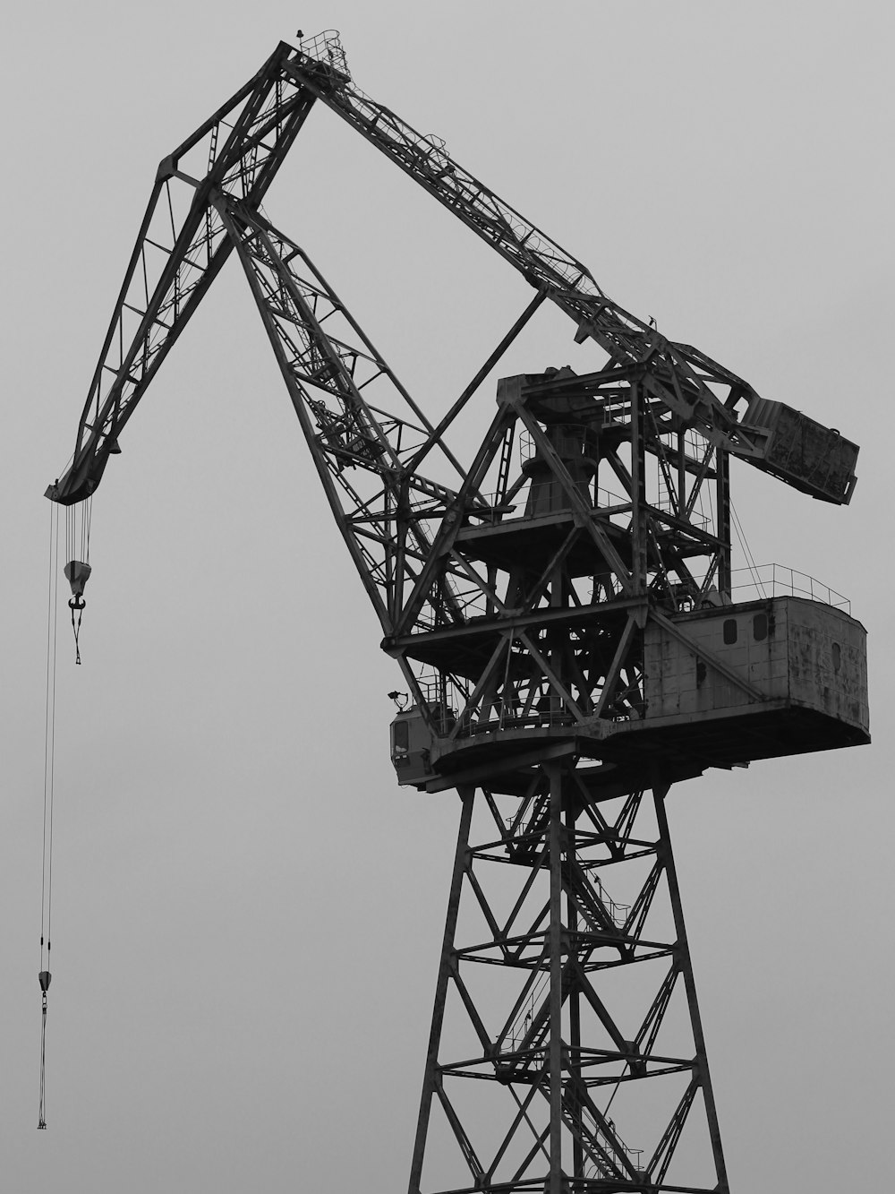 grayscale photo of crane machine