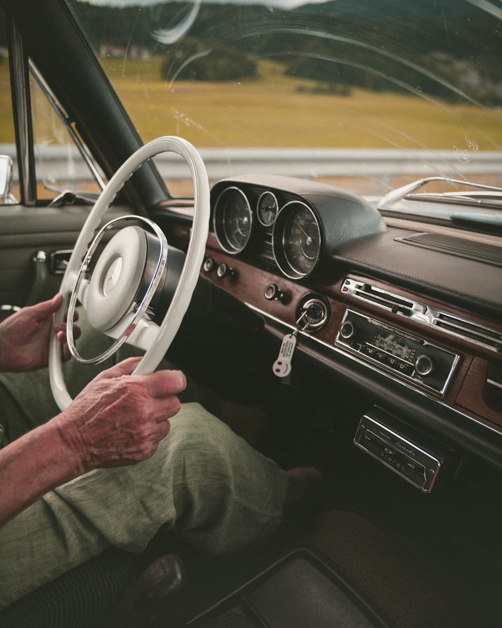 man driving classic car during day
