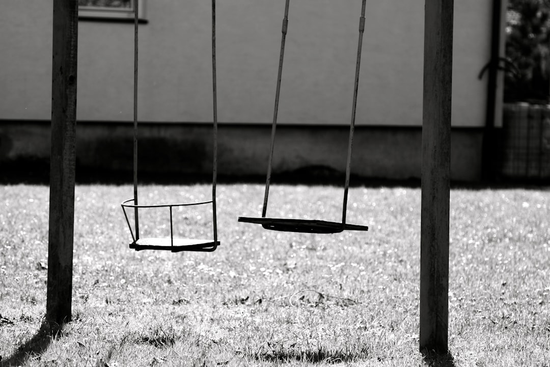 two empty swings grayscale photography
