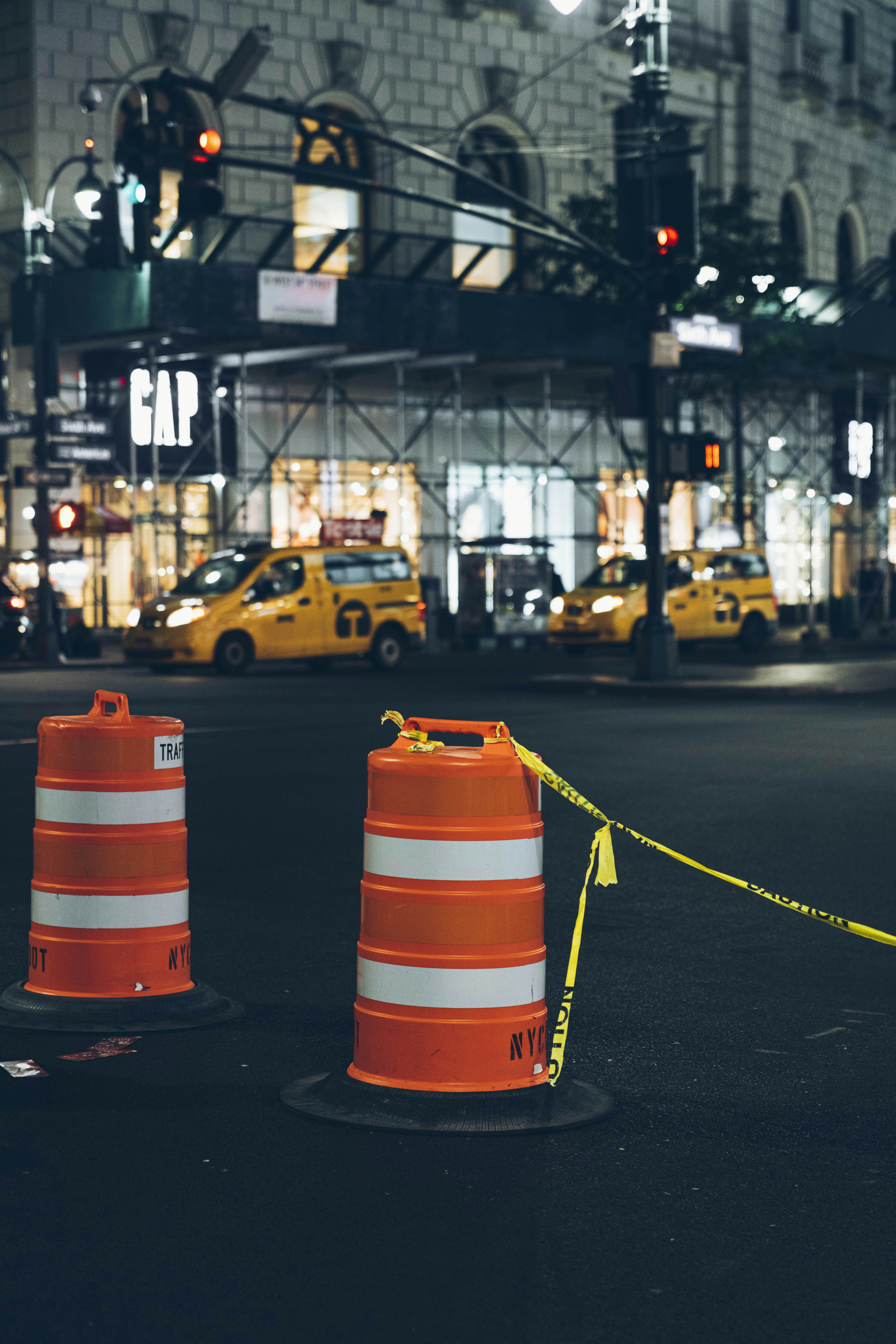 orange traffic cones with yellow tape