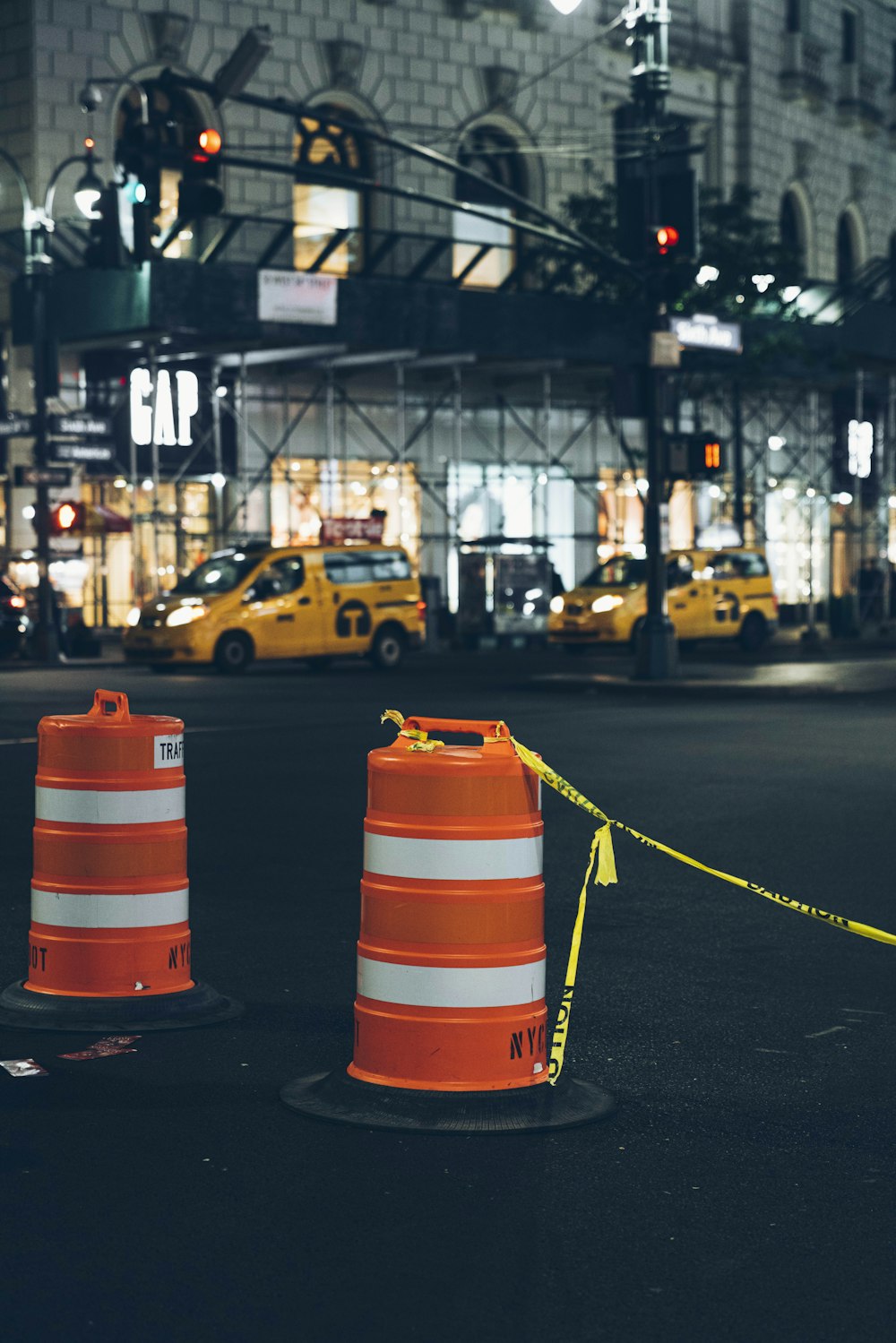 orange traffic cones with yellow tape