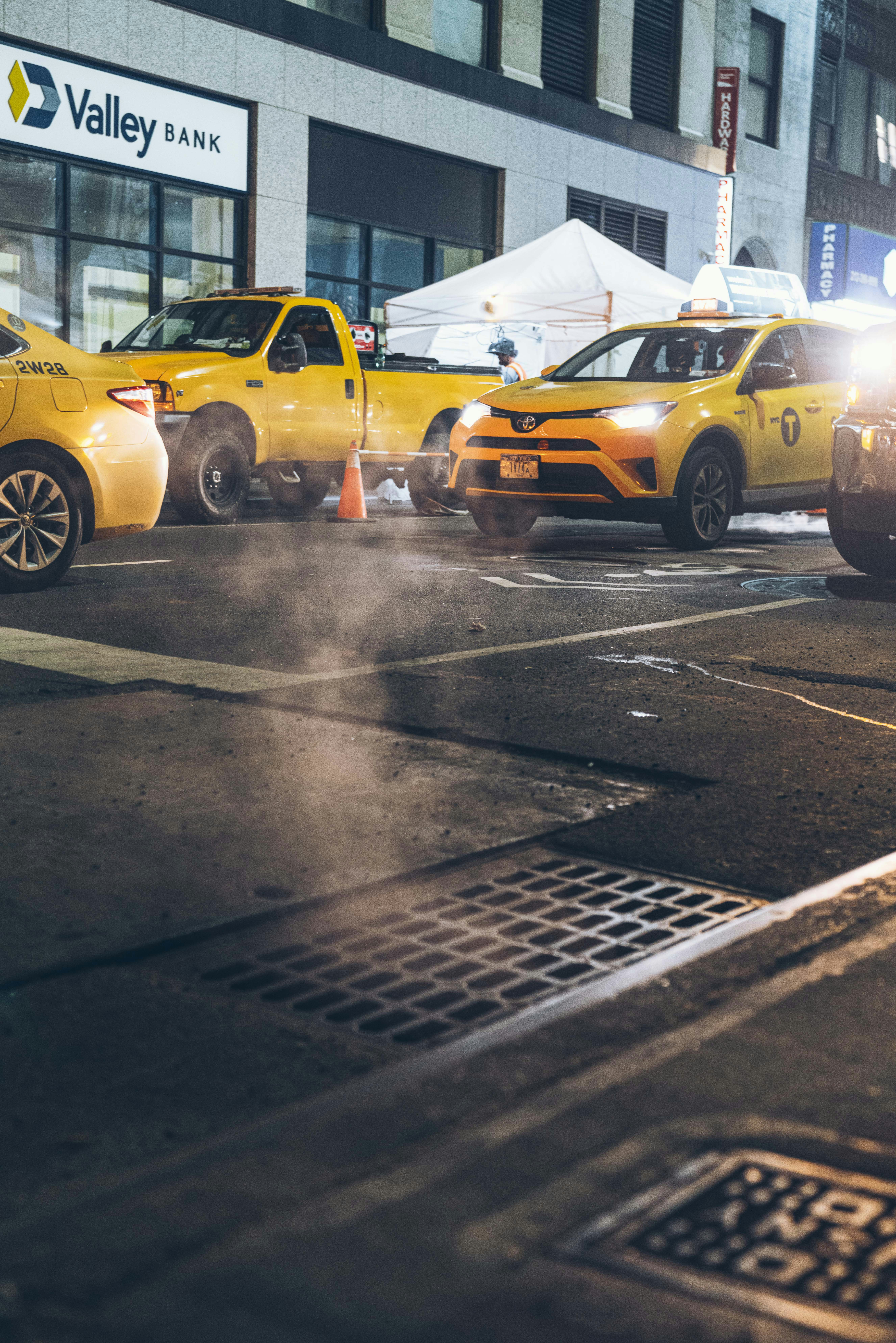 a city street filled with traffic next to tall buildings