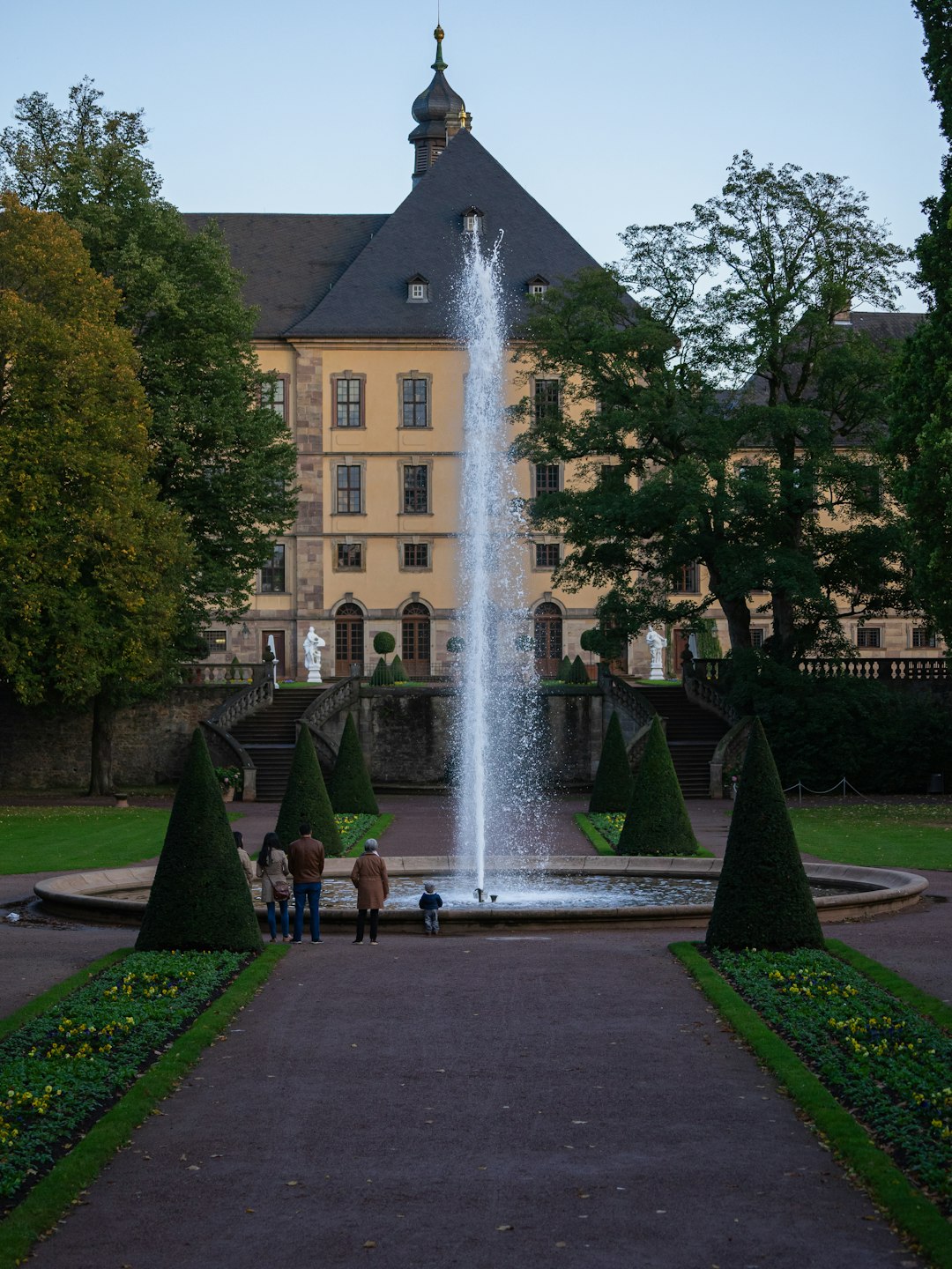 photography of people standing beside fountain during daytime