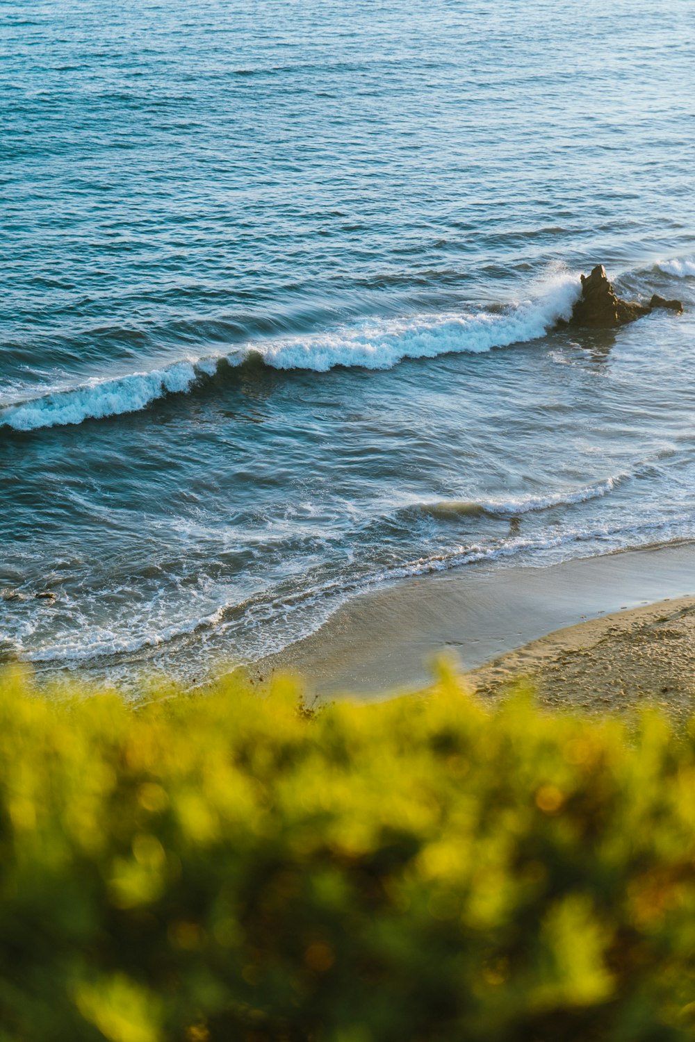 sea waves crashing on shore during daytime