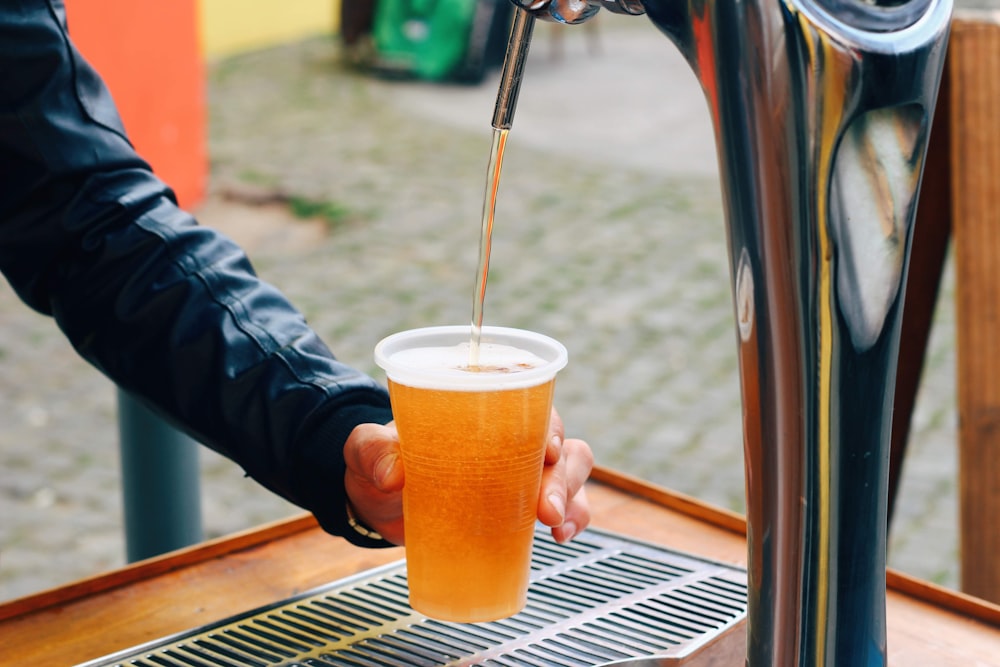 person holding cup of beverage