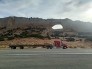 red semi trailer truck on road