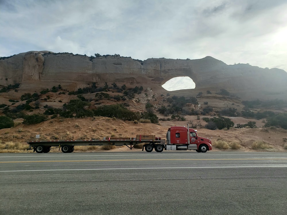 red semi trailer truck on road