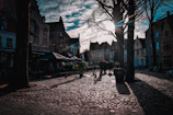 A charming cobblestone street in a historic European city at sunset