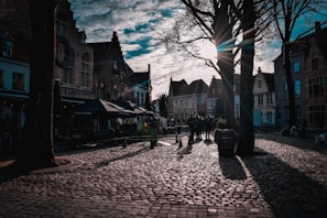 A charming European cityscape with cobblestone streets and historic architecture at sunset.