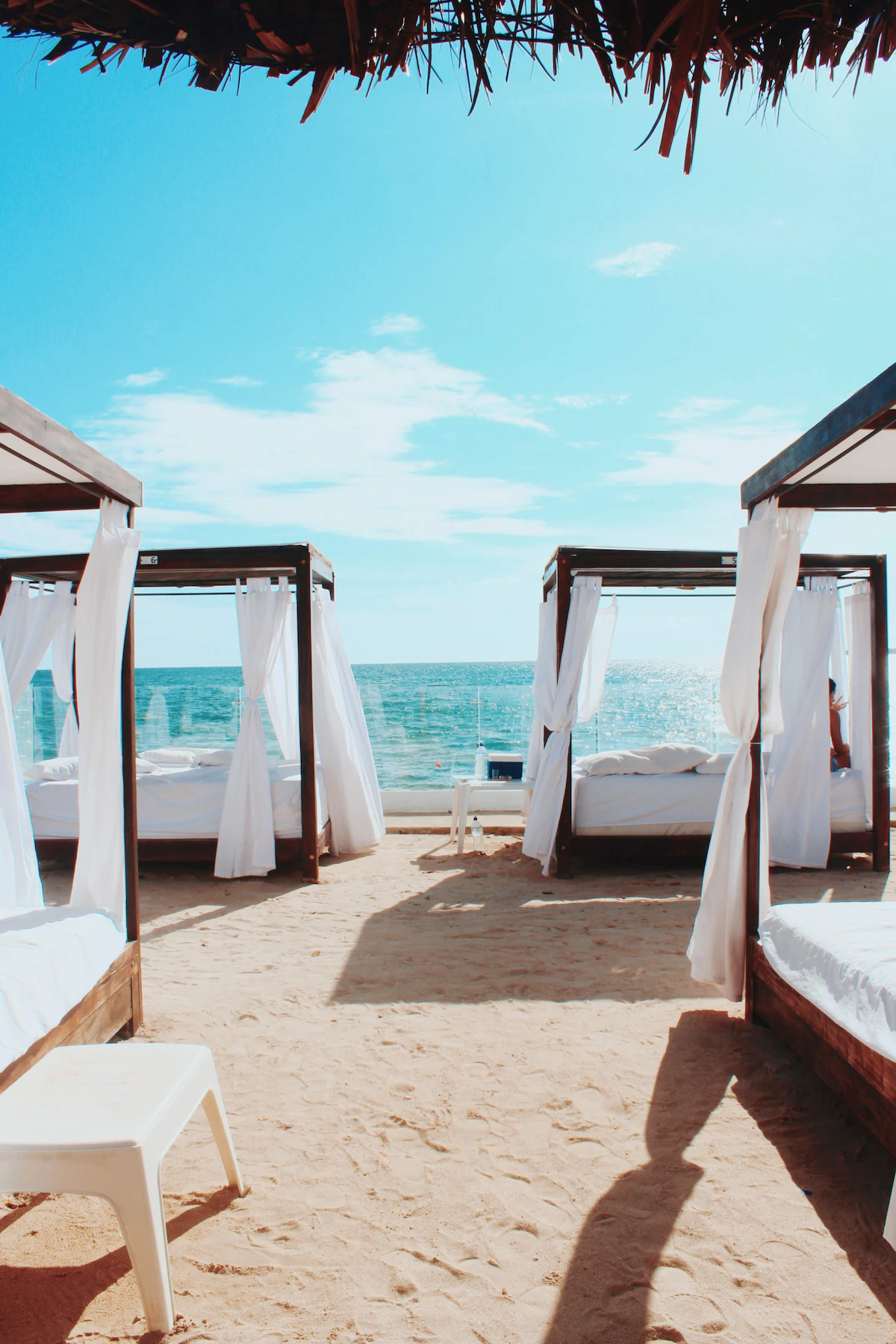 Tropical beach with lounge chairs