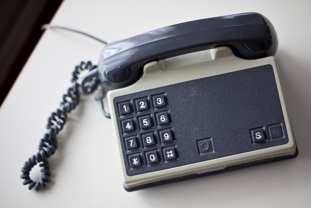 grey and white home telephone