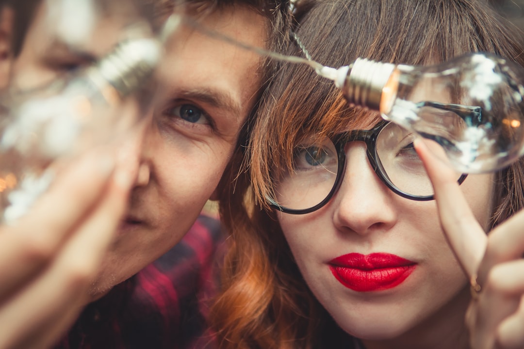 couple holding clear bulbs