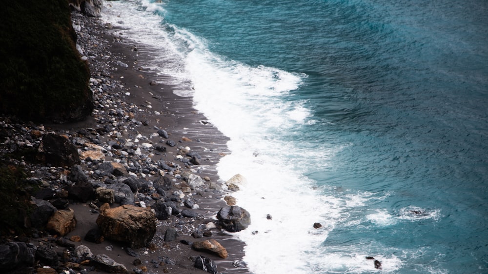 gray and brown rocks near body of water