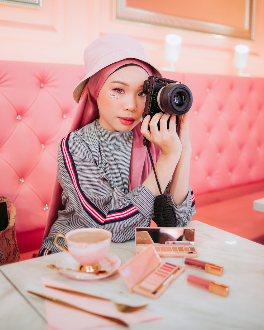 woman holding black bridge camera