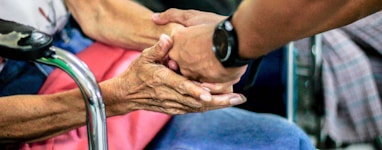 man holding hand with woman on chair