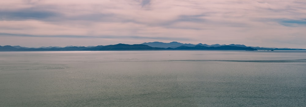 ocean and mountain island during day