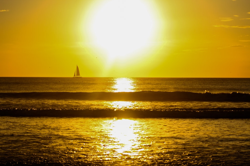sailboat floating at the ocean during golden hour