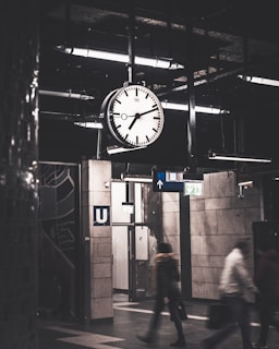 analog hanging ceiling clock displaying 7:11 time
