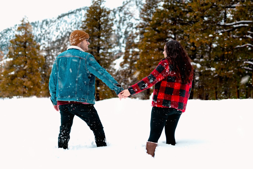 shallow focus photo of man and woman holding each others hands