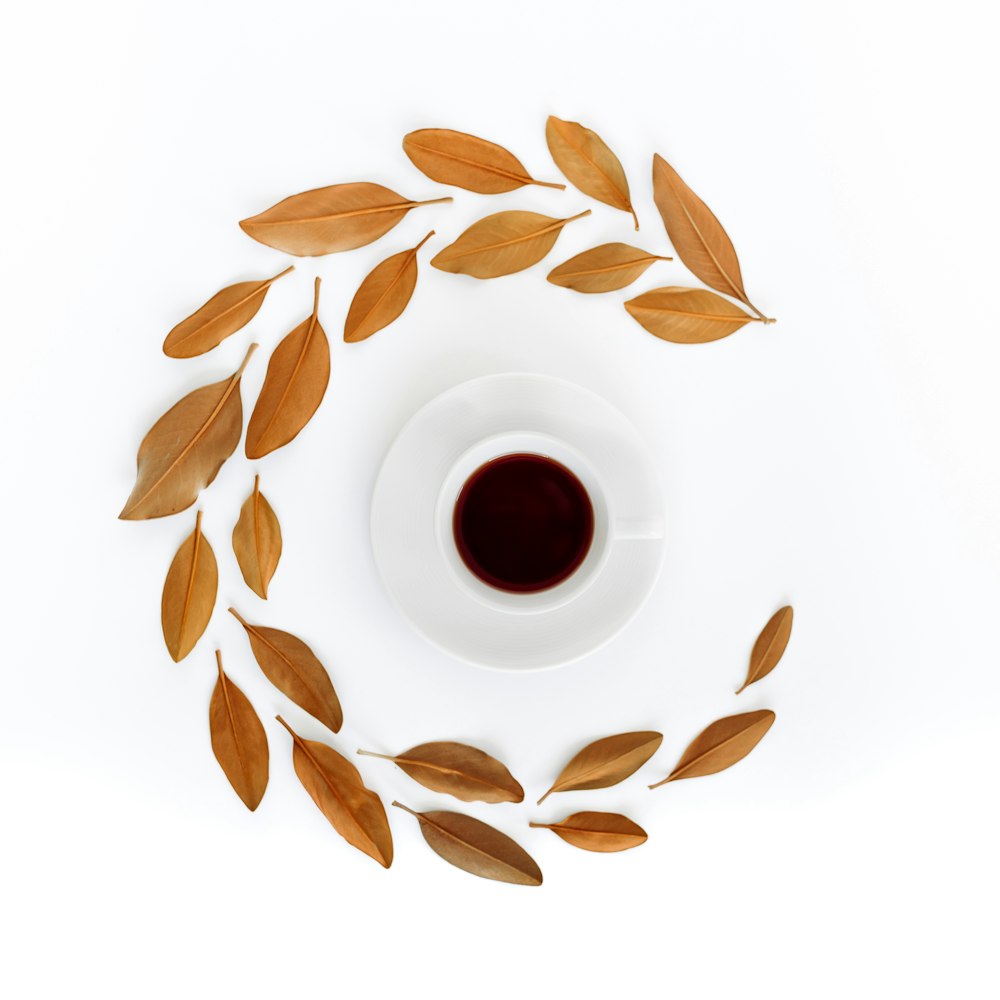 white ceramic teacup filled with maroon liquid