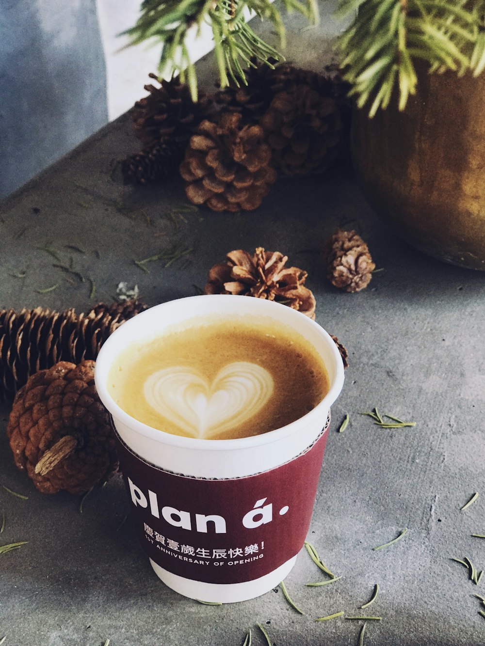 brown liquid in white and maroon plastic cup