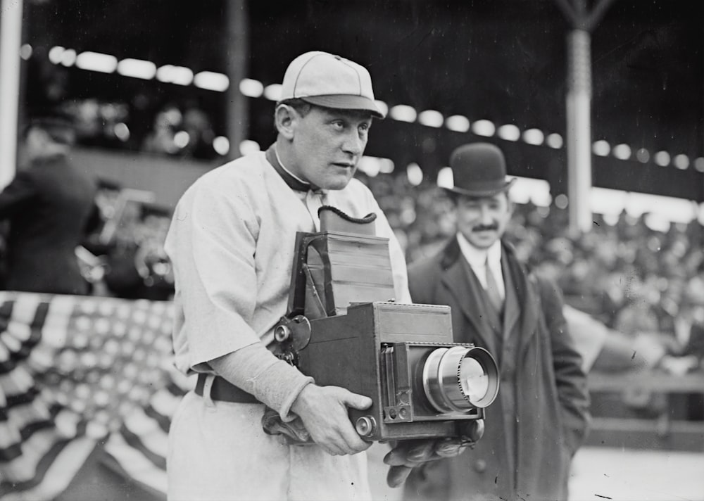 Germany Schaefer, Washington AL (baseball) holding a photographer's camera