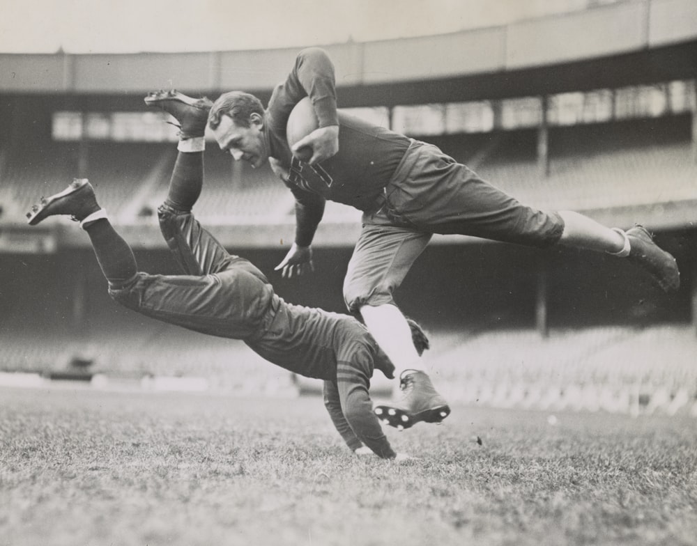 Football players Red Grange and Joe Zeller during practice