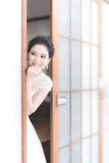 A candid moment of the bride smiling warmly as she prepares for the ceremony