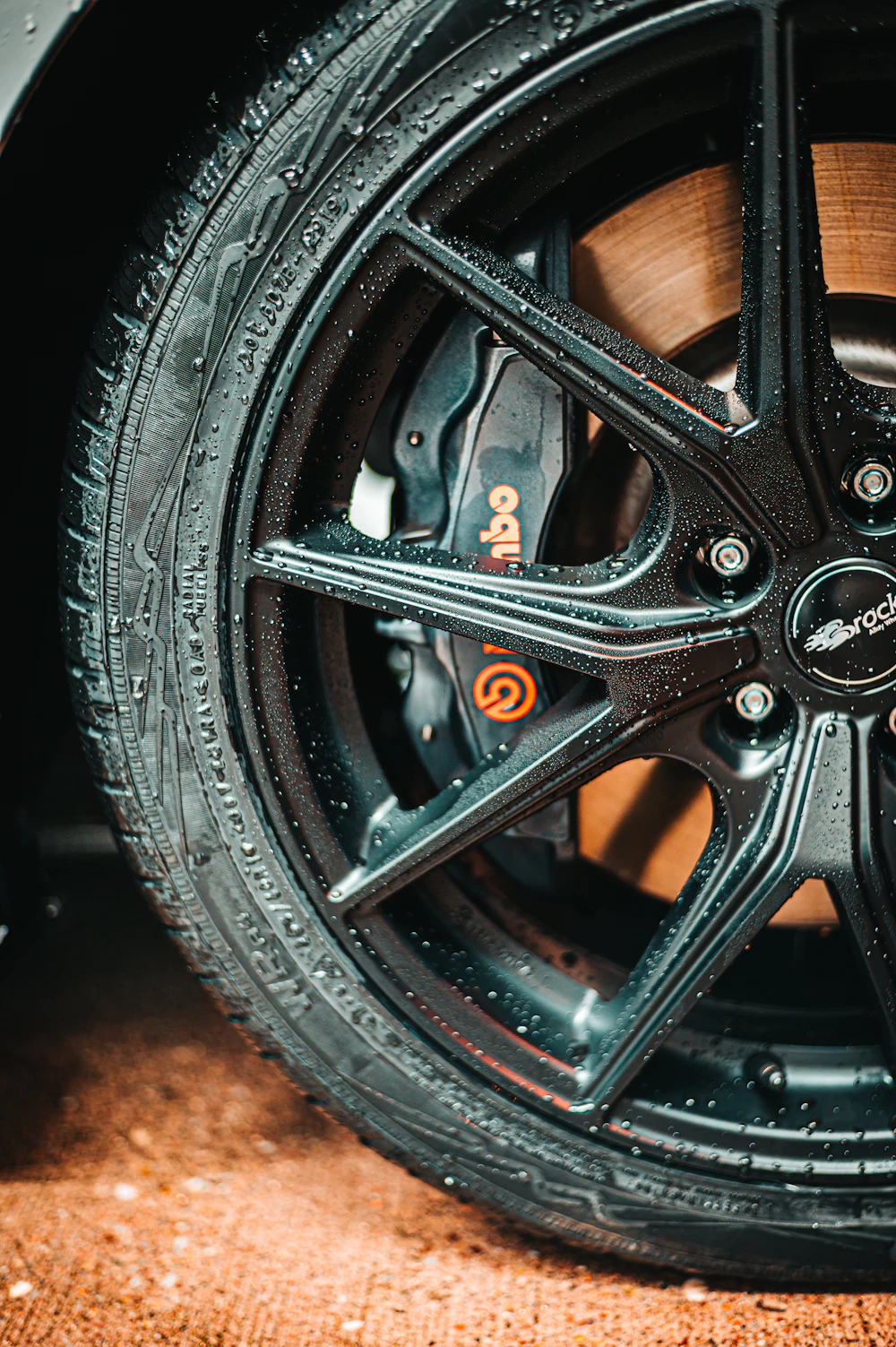 Clean black multi-spoke alloy wheel with a freshly dressed tyre