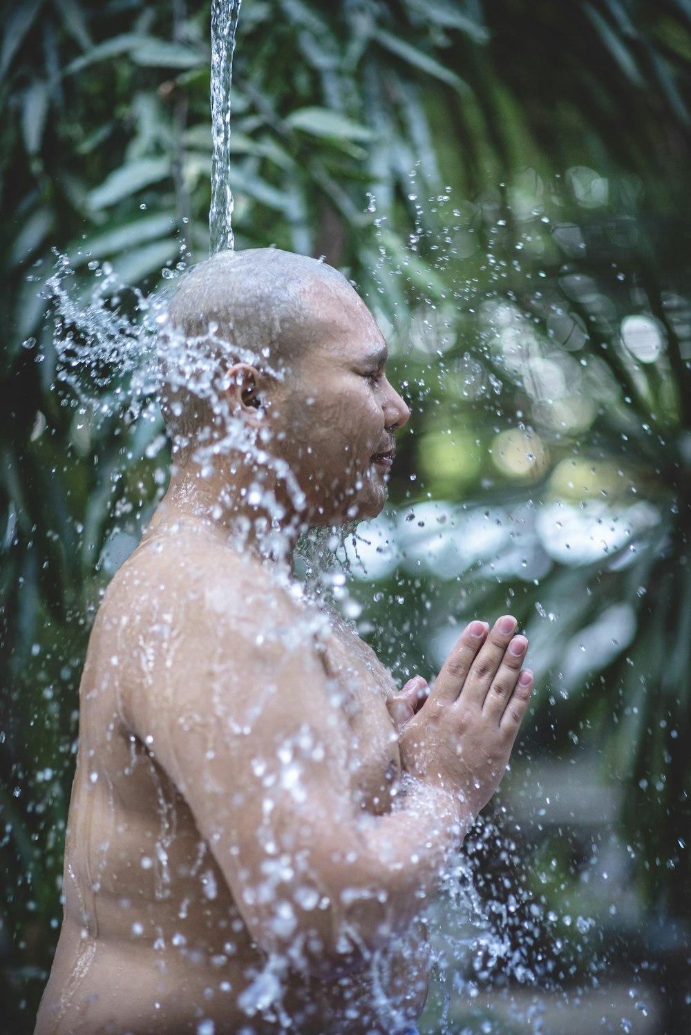 time-lapse photography of water pouring all over a man