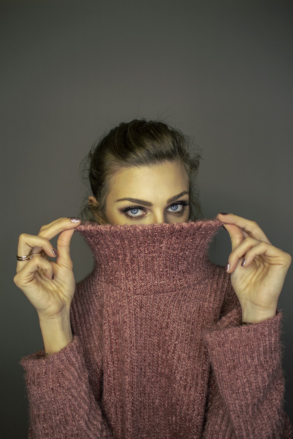 woman in pink turtleneck sweater