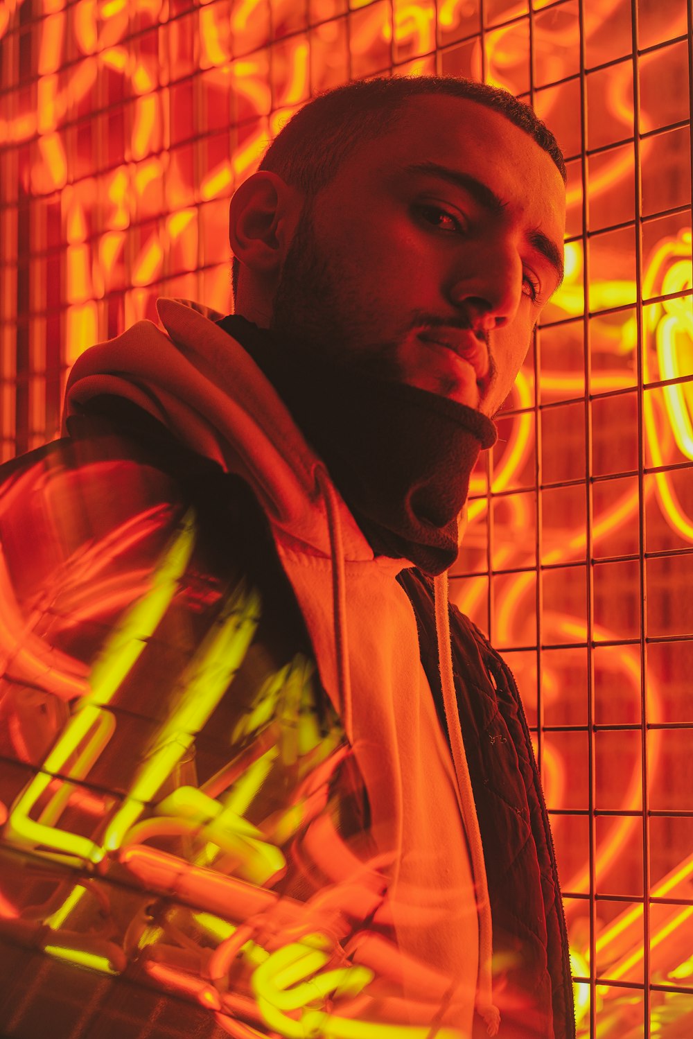 man in red hoodie beside screen